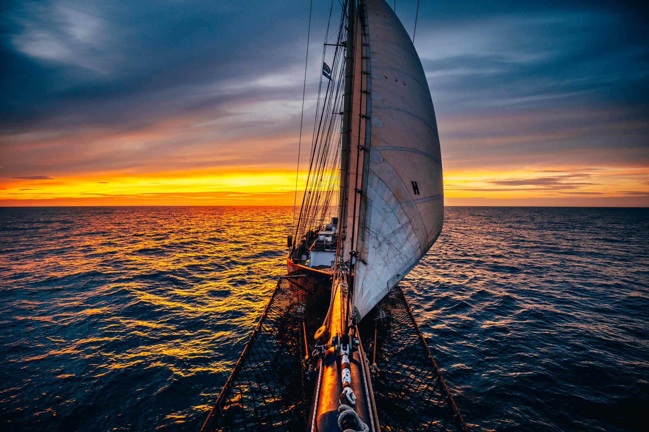Dramatic sunset on a tall ship at sea