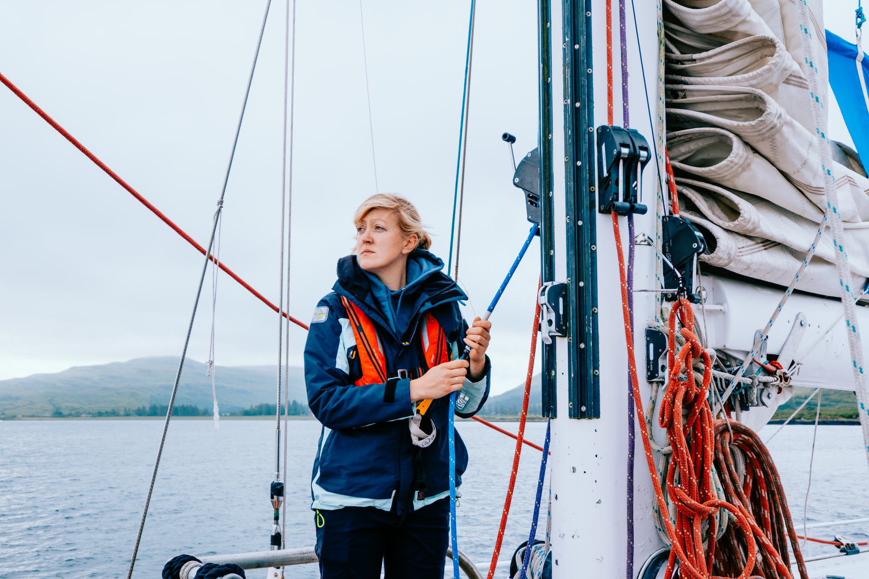 Woman looking out from a boat sailing at sea