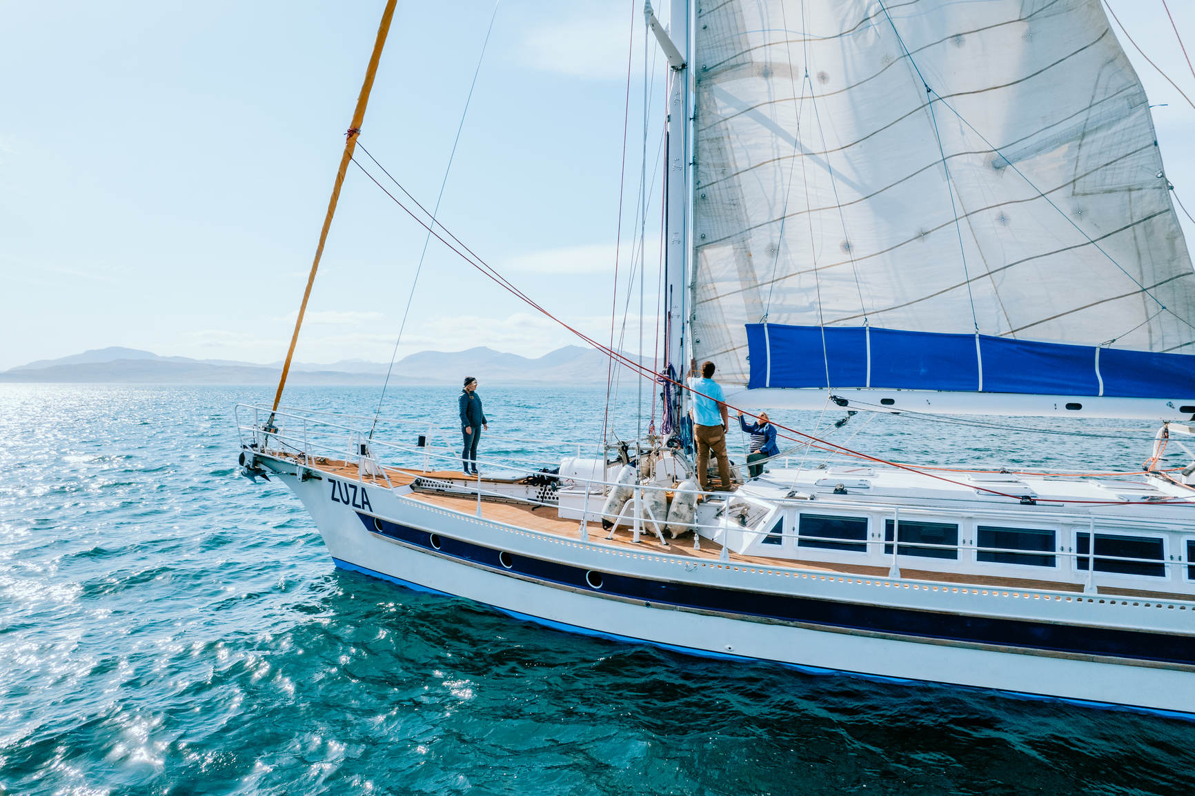 People on a boat sailing at sea in the sun