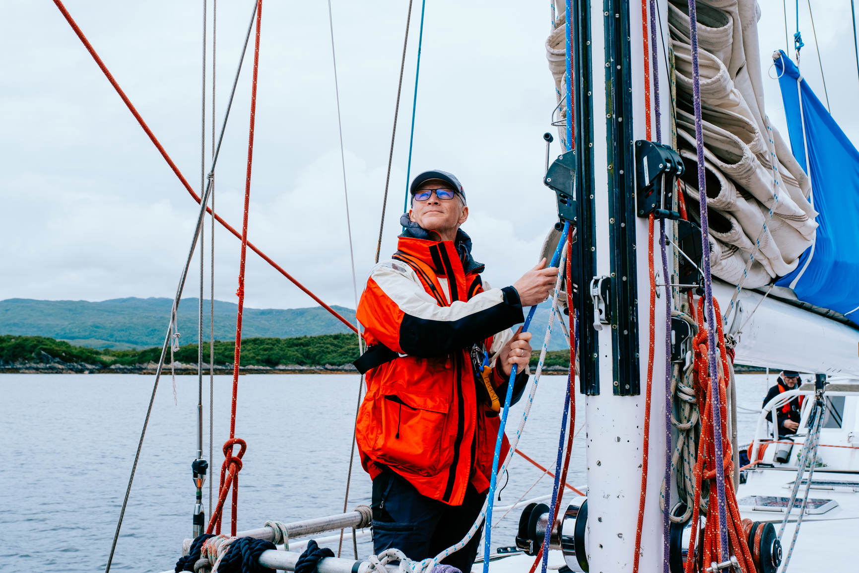 Man working the sales on a boat at sea