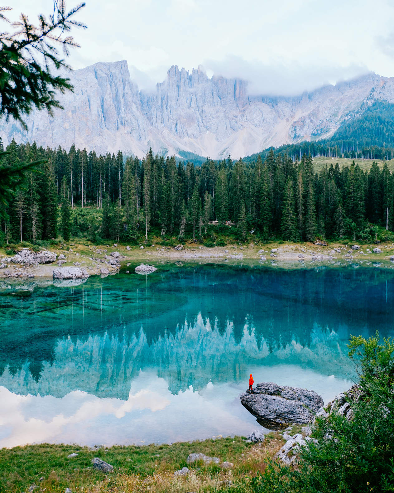 Man standing at Carezza Lake in the Italian Dolomites